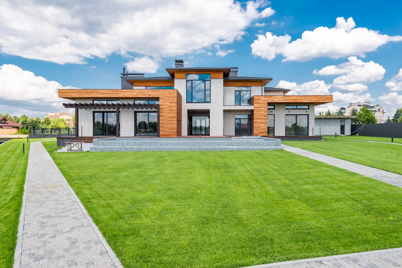 Stunning modern house exterior showcasing spacious lawn and contemporary architecture.